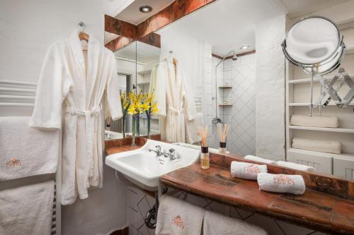 a bathroom with a sink and a mirror at HOMOKI LODGE Bed & Beyond Glamping Adult Only in Ruzsa