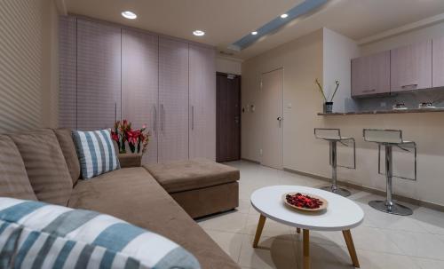 a living room with a couch and a table at Amazing Apartments @ Monastiraki Subway Station in Athens