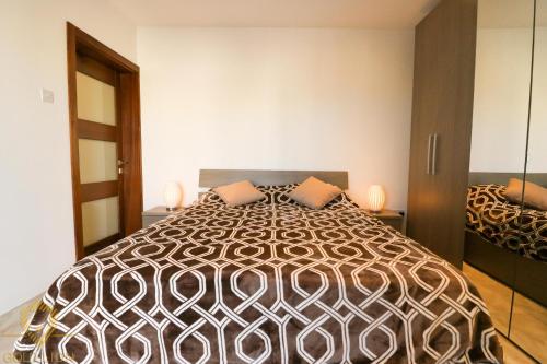 a bedroom with a large bed with two pillows on it at BelAir Flats 3 Bedrooms Apartment in St Julians in St Julian's