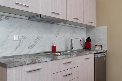 a kitchen with a sink and a counter top at Amazing Apartments @ Monastiraki Subway Station in Athens
