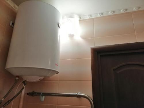 a white light in a bathroom next to a door at Apartments on Dontsya, 12 in Kyiv