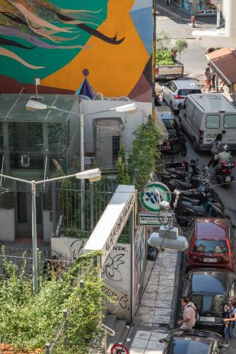 an overhead view of a parking lot with cars and motorcycles at Amazing Apartments @ Monastiraki Subway Station in Athens