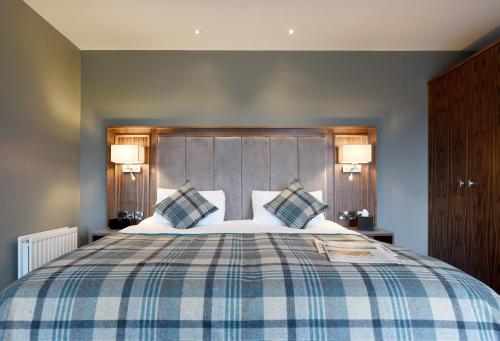 a bedroom with a large bed with two pillows at Golflinks Hotel in Portrush