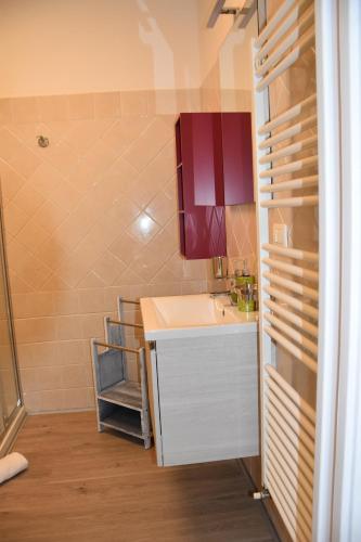a small bathroom with a sink and a red cabinet at BB Ombretta in Valeggio sul Mincio