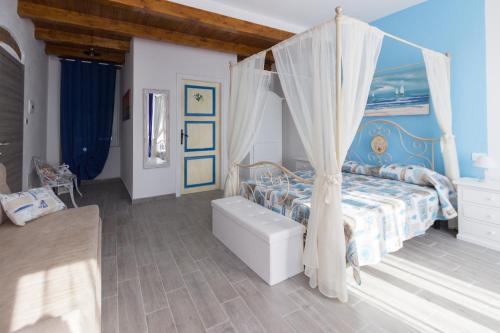 a bedroom with a bed with a canopy at Casato Bapo camera panoramica Aurora in Riomaggiore