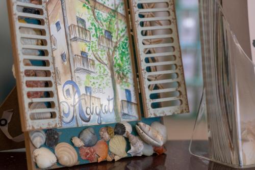 a container filled with rocks and shells on a table at Hotel Adigrat in Riccione