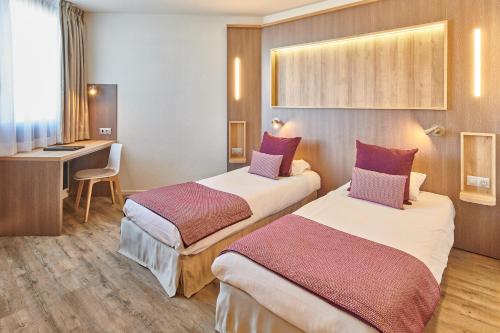 Un pat sau paturi într-o cameră la Hôtel Le Bayonne