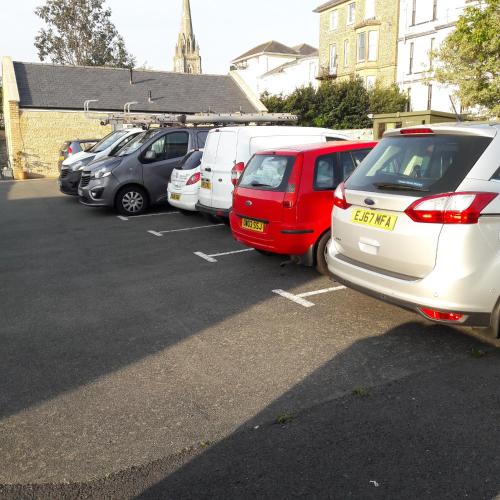a row of parked cars in a parking lot at Dorset Hotel, Isle of Wight in Ryde