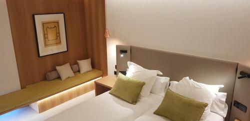 a hotel room with a white bed with pillows at Protur Naisa Palma Hotel in Palma de Mallorca