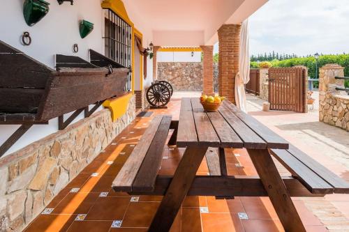 a wooden picnic table on the patio of a house at Casas Guemon in Zahora