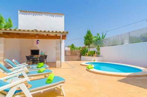 a patio with lounge chairs and a swimming pool at Can Pistola in Algaida
