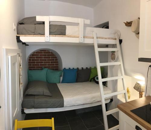 a bedroom with two bunk beds and a ladder at Cute Mykonos DownTown Studio in Mikonos