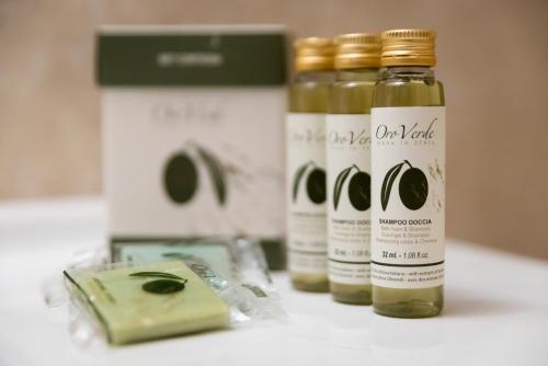 two bottles of olive oil sitting on a counter at ApartHotel Anghel in Siena