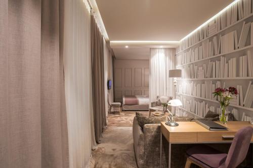 a living room with a desk and a room with at Jump INN Hotel Belgrade in Belgrade