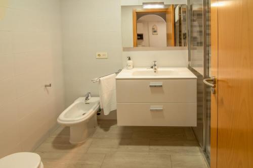 a white bathroom with a sink and a toilet at El Medano La Perla C7 in El Médano