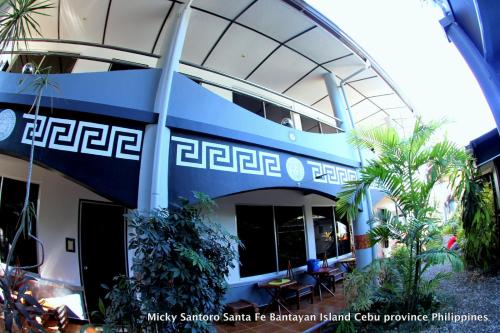 a building with a blue and white facade at Micky Santoro Hotel & Restaurant in Bantayan Island