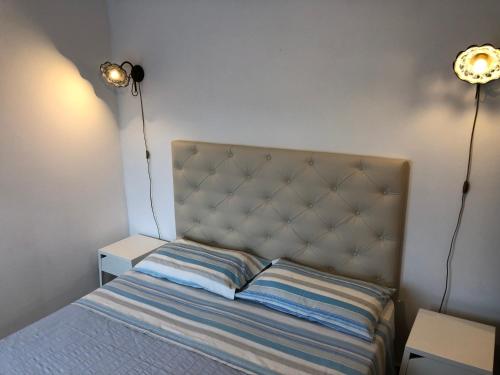 a bedroom with a bed with two lamps on it at B&B Villa sul Mare in Melito di Porto Salvo