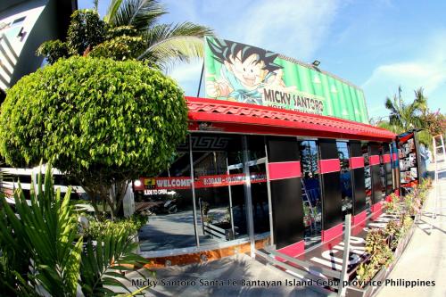 a building with a sign on the side of it at Micky Santoro Hotel & Restaurant in Bantayan Island