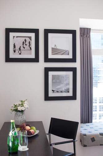 a dining room with a table and pictures on the wall at Benjamin Business Hotel in Herzelia 