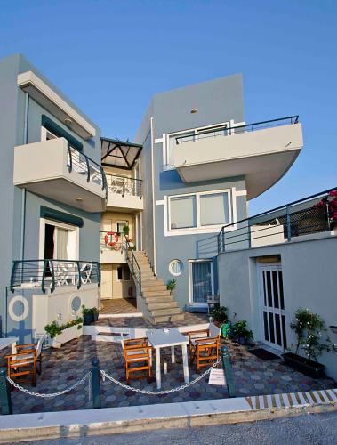 a house with a table and chairs in front of it at Sea Breeze in Kalamaki Chanion