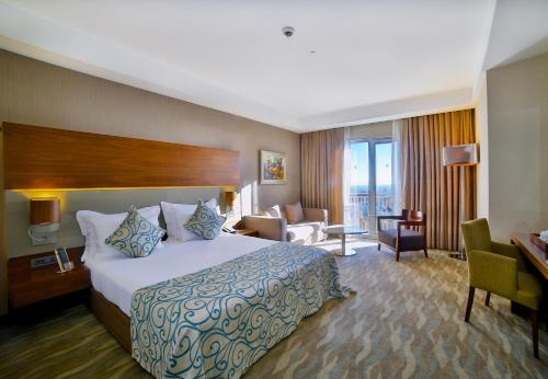 a hotel room with a large bed and a desk at Innova Sultanahmet Istanbul in Istanbul