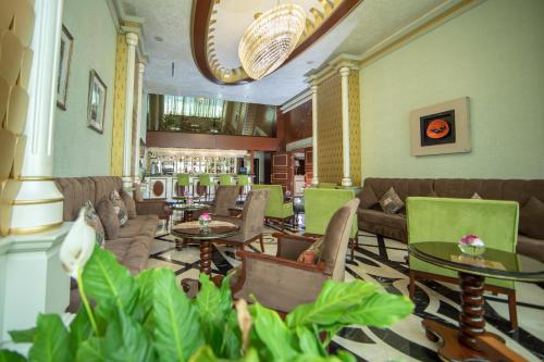 a hotel lobby with couches and tables and plants at Sapphire Hotel in Baku