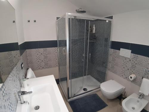 a bathroom with a shower and a toilet and a sink at La Lobra Dépendance in Massa Lubrense