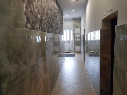 a hallway in a building with a tile floor at Marcus in Bydgoszcz