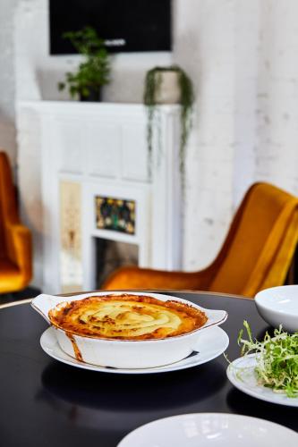a pie on a plate on a table at The Buxton in London