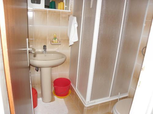 a small bathroom with a sink and a toilet at Apartments Ruzica - 50 m from sea in Jezera