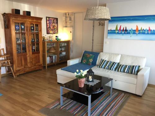 a living room with a white couch and a coffee table at Maupin Stéphane in Saint-Gilles-Croix-de-Vie