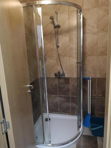 a shower with a glass door in a bathroom at Balchik Sea View Apartments in Princess Residence in Balchik