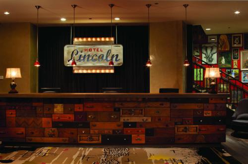 a bar with a neon sign on the wall at Hotel Lincoln, part of JdV by Hyatt in Chicago