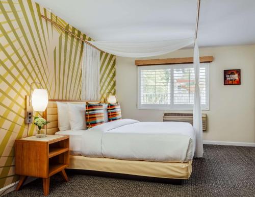 a bedroom with a large bed and a window at Wild Palms, a JdV by Hyatt Hotel in Sunnyvale