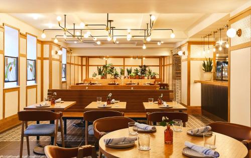 a restaurant with tables and chairs and a dining room at Hotel Revival Baltimore in Baltimore