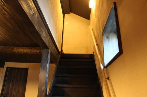 a staircase in a building with a window at Koiya in Kameoka