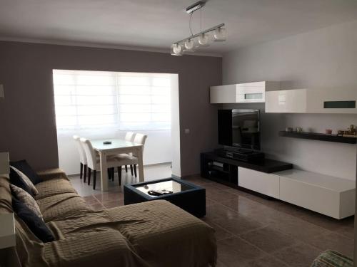 - un salon avec un canapé et une table dans l'établissement Piso céntrico 2 habitaciones cerca del mar, à Hospitalet de l'Infant