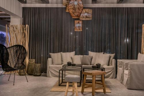 a living room with a couch and a table and chairs at Avithos Resort Hotel in Svoronata