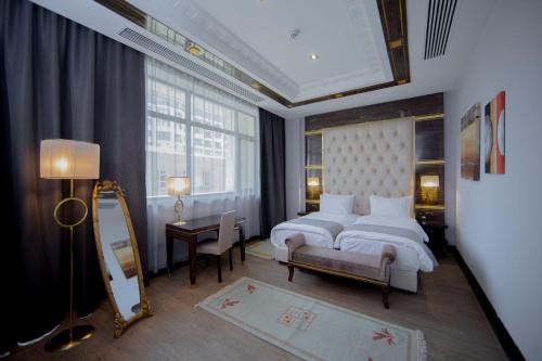 a bedroom with two beds and a mirror at Sapphire Hotel in Baku
