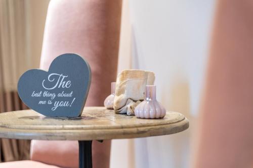 a table with a heart sign on top of it at Mikelina Boutique Hotel in Pallíni