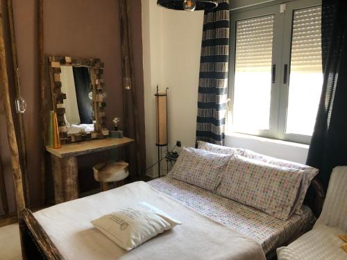 a living room with a couch and a mirror at Relux Suite in Agios Nikolaos