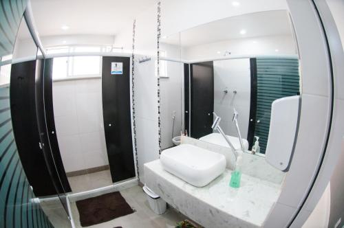 a bathroom with a sink and a mirror at Icaraí Bed & Breakfast in Niterói