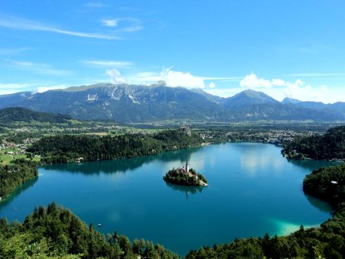 an island in the middle of a lake at Castle way Apartments Tamy in Bled