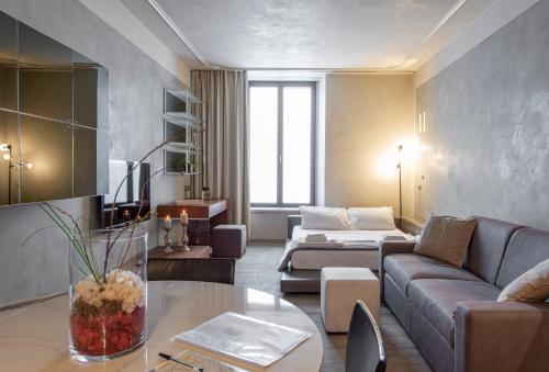 a living room with a couch and a table at Milan Royal Suites - Centro in Milan