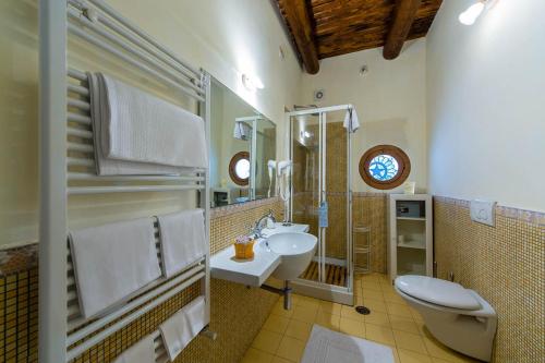 a bathroom with a sink and a toilet and a mirror at B&B Beata Solitudo in Agerola