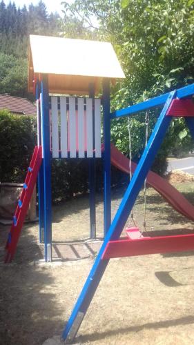 a playground with a slide and a swing at Lillie 3-4 Personen - Ferienwohnungen Wagner & Gaul Falkenauel in Falkenauel