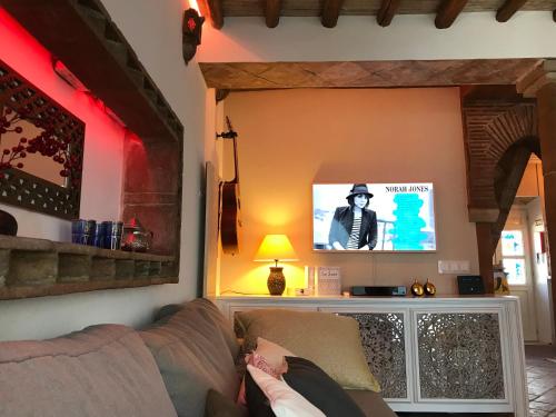 a living room with a couch and a tv at Beachhouse Algarve, Beach 50m in Salema