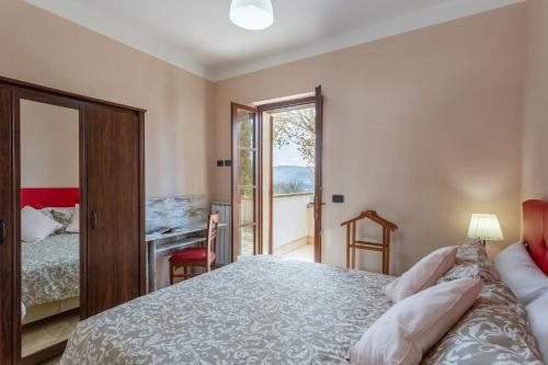 a bedroom with a bed and a table and a desk at GH Borgo Pulciano Agriturismo in Montone