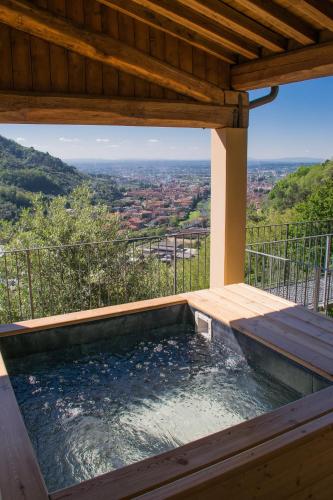 a hot tub on a deck with a view at Podere Scoglio d'Oro in Pescia