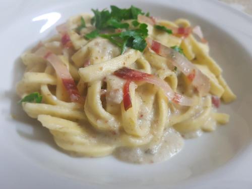 a plate of pasta on a white plate at Borgo Santa Lucia in Cropani